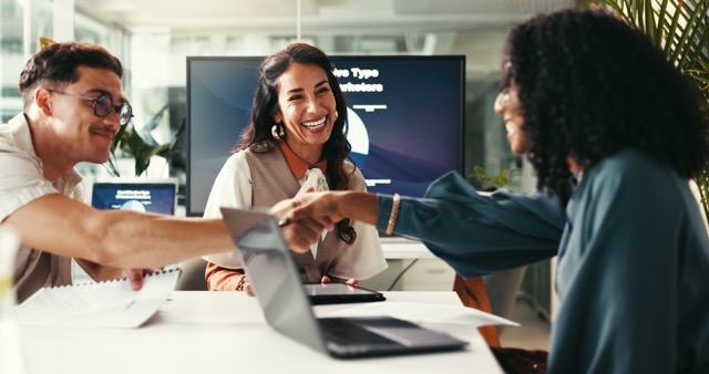 Happy business people shaking hands for deal, brand sponsorship or collaboration.